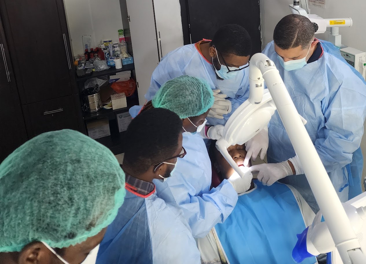 Dental surgical team treating a patient in an operatory